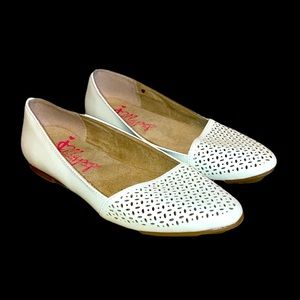 White leather Jelly Pop brand women’s flats with holes across leather on toes